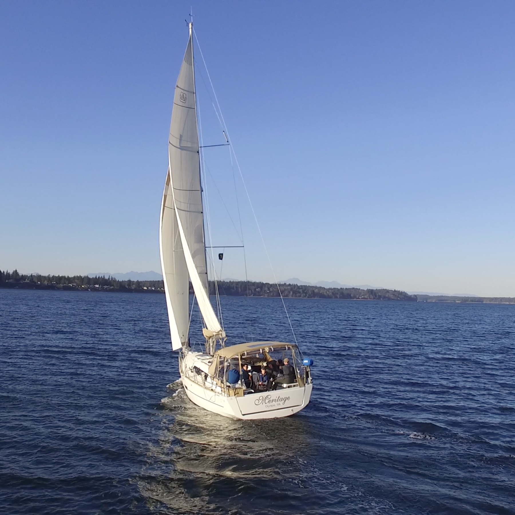 Meritage sailing on Puget Sound with guests gathered in the cockpit.