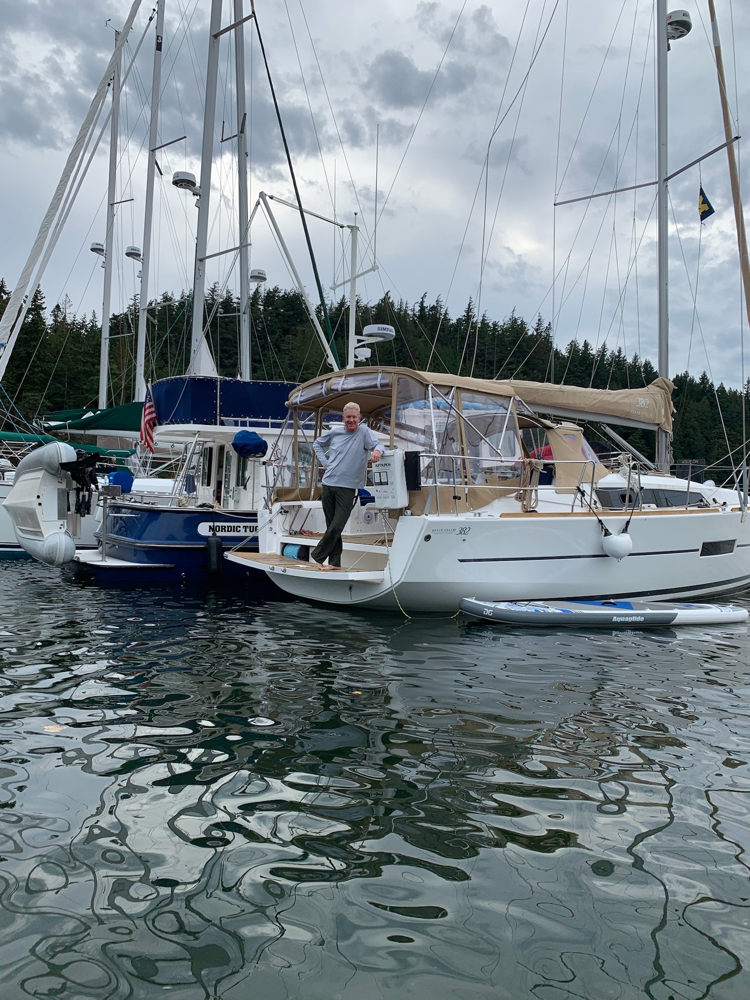 Sailboats rafted together in calm water.
