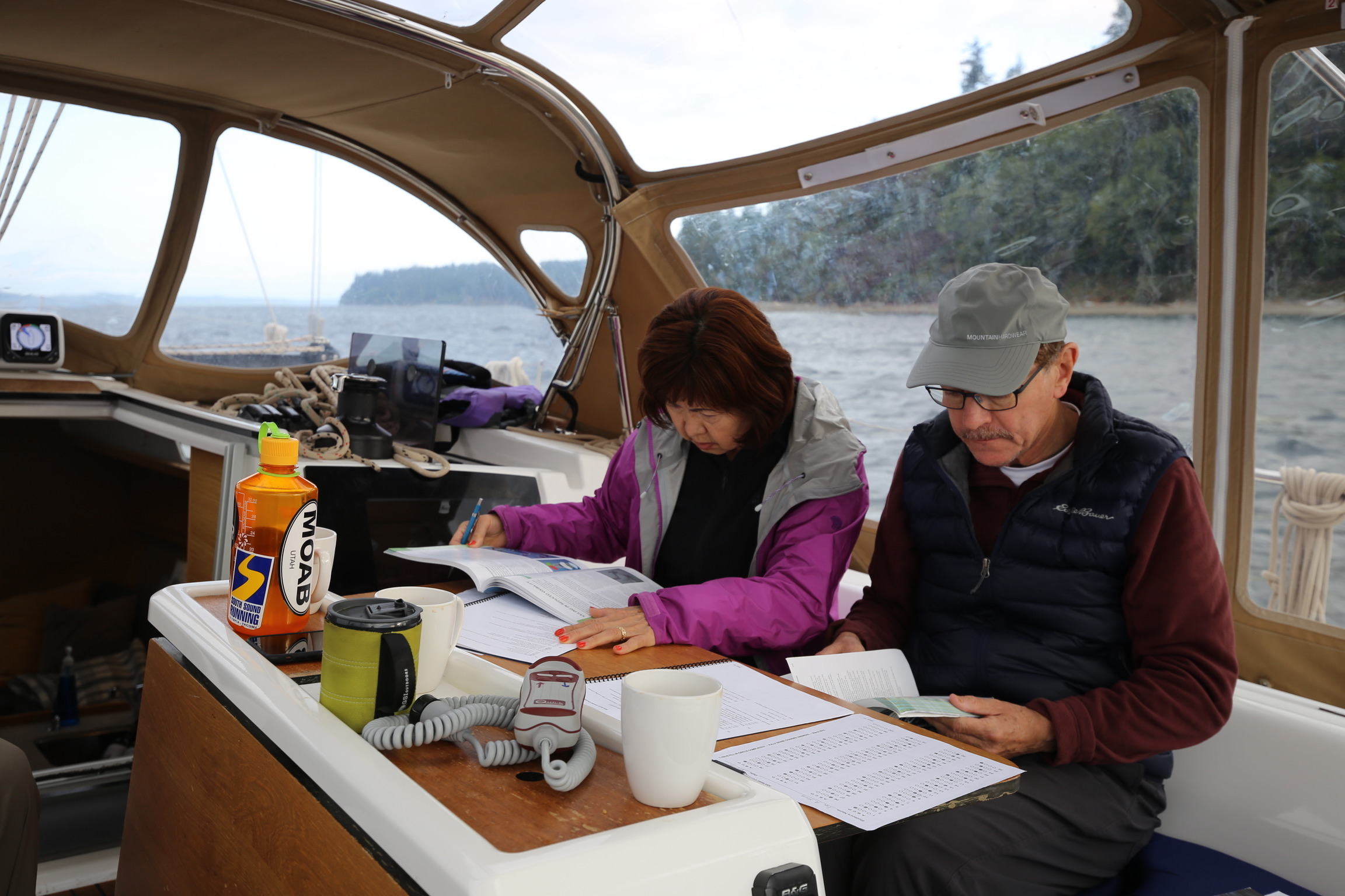 Students working on navigation at the cabin table.