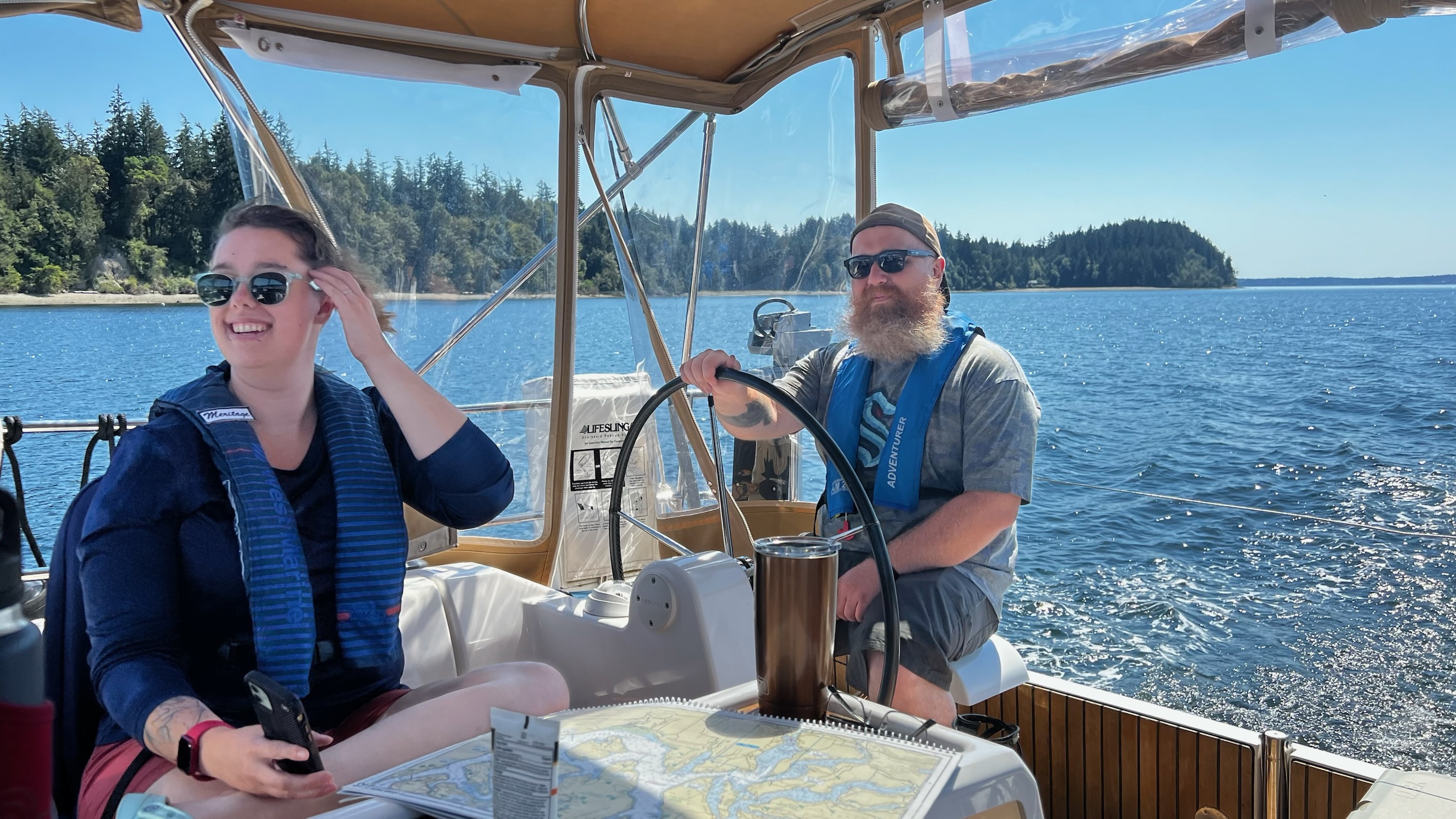 Two guests smiling in the cockpit.