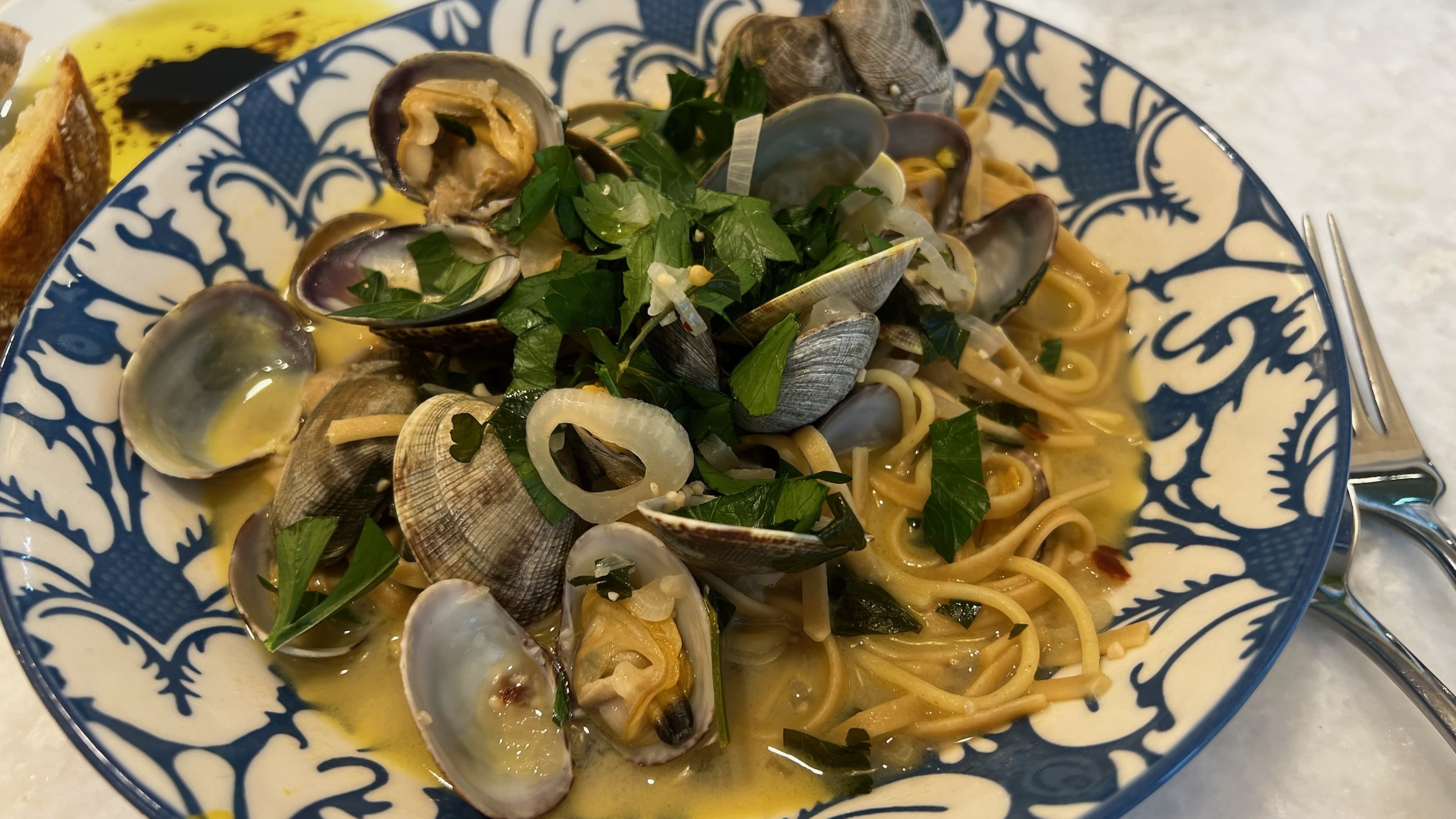 A bowl of clams and pasta aboard.